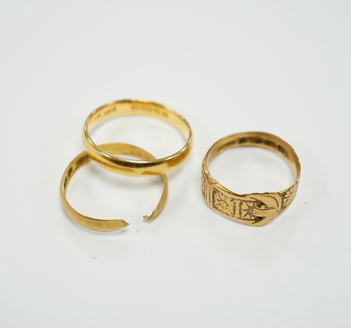 Two 22ct gold wedding bands (one cut), 5.8 grams and an 18ct gold buckle ring, 2.9 grams.